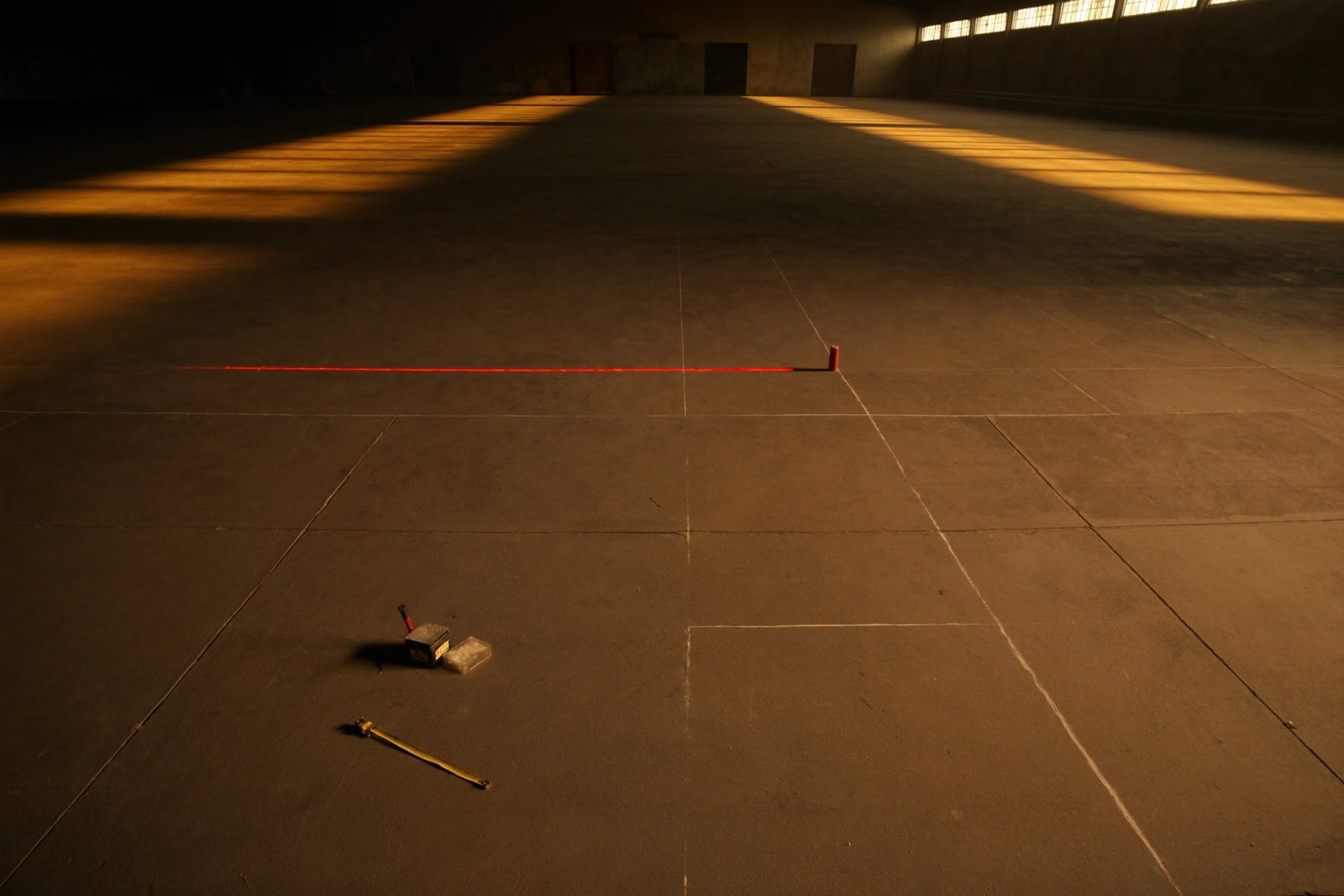 A bare marked floor being measured out before install.